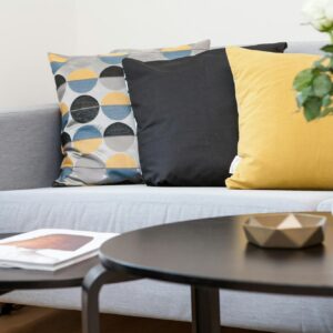 Centerpiece on Coffee Table Beside Sofa With Three Pillows